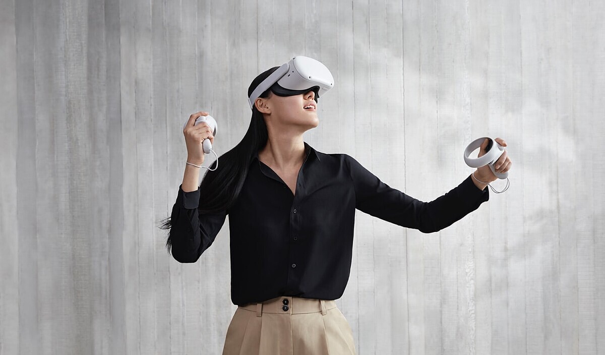 Woman playing a game with the Oculus Quest 2 headset and Touch controllers